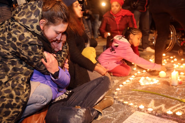 Two young girls cry as people gather to leave tributes at the Place de la Bourse in Brussels, Belgium, following Tuesday's&nb