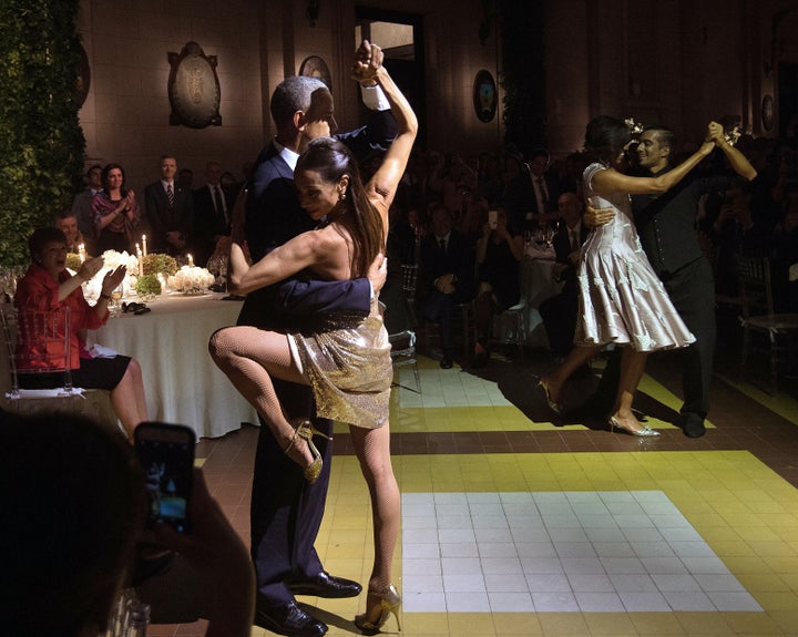 US President Barack Obama (L) and First Lady Michelle Obama (2nd R) dance tango with dancers during a state dinner at the Kirchner Cultural Centre in Buenos Aires on March 23, 2016