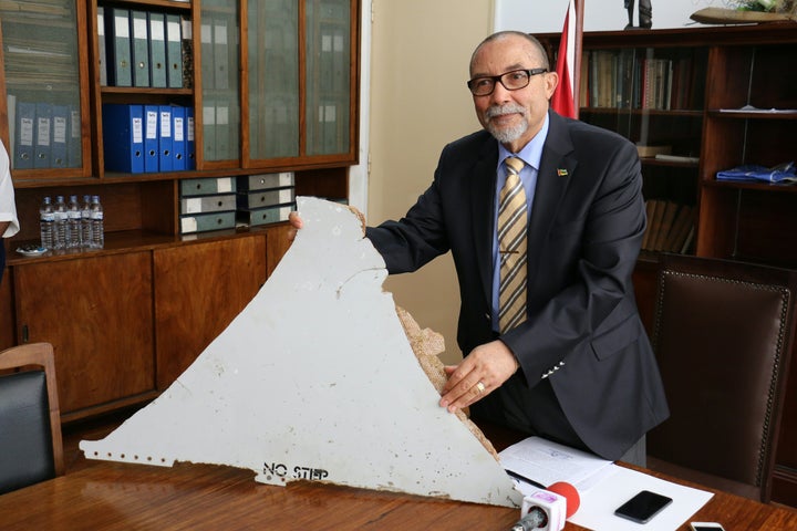 Joao de Abreu, president of Mozambique's Civil Aviation Institute, holds a piece of suspected aircraft wreckage found off the