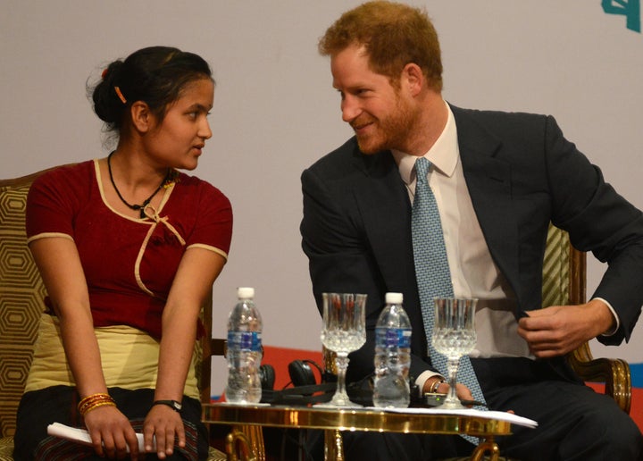 Britain's Prince Harry (R) speaks with a guest during the start of the Nepal Girls Summit 2016 in Kathmandu on March 23, 2016