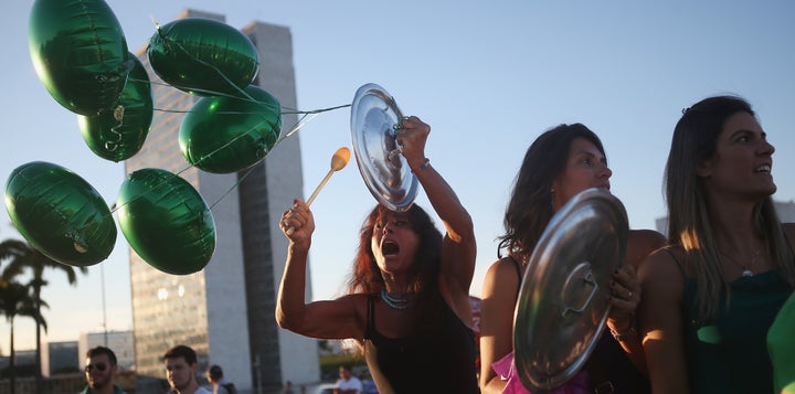 Brazilian anti-government protestors chant outside the National Congress on March 21, 2016 in Brasilia.