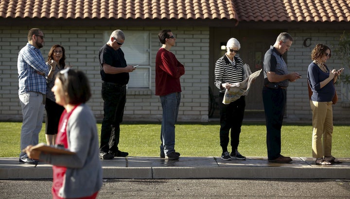 People wait to vote in the U.S. presidential primary election outside a polling site in Arizona on March 22, 2016.