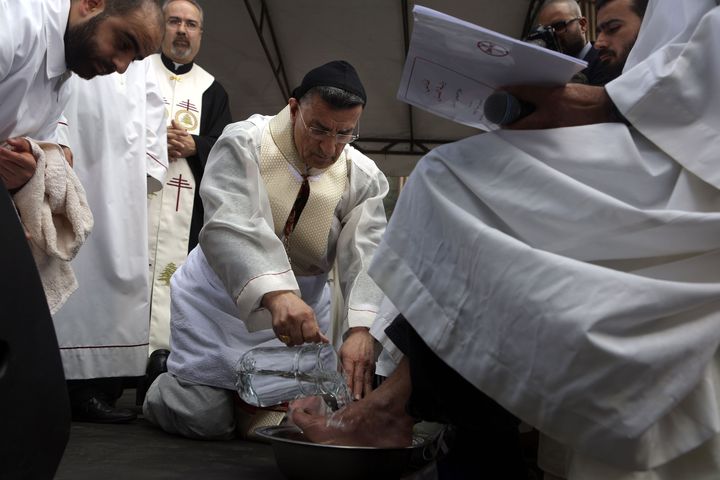 Lebanon's Cardinal Mar Bechara Boutros al-Rai, the Maronite Patriarch of Antioch and the Whole Levant, washes prisoners feet during the Maundy Thursday Mass at Lebanon's Roumieh prison, northeast of Beirut on March 24, 2016.