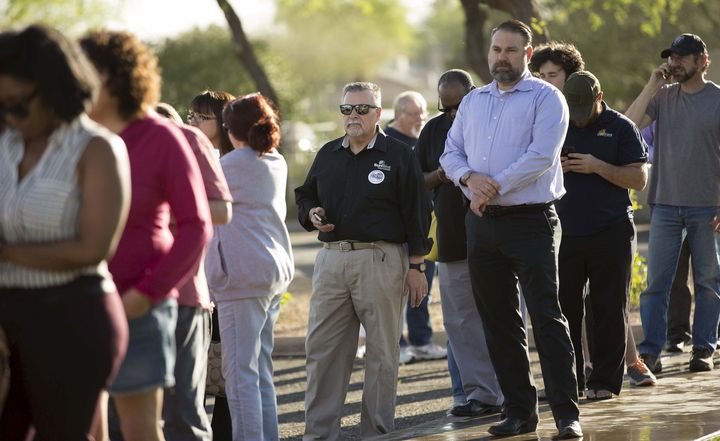 People wait to vote in the U.S. presidential primary election outside a polling site in Glendale, Arizona, March 22, 2016.
