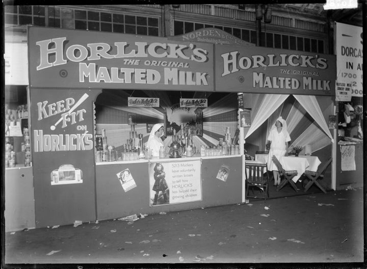 A stall at a 1930 tradeshow advertises Horlick's malted milk as a health tonic: "5213 mothers have voluntarily written letters to tell how HORLICK'S has helped their growing children," a sign states.