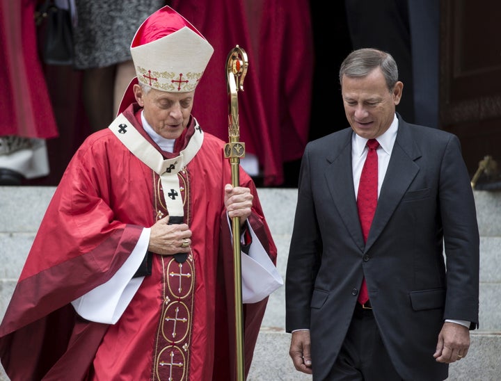 Supreme Court Justice John Roberts, right, speaks with Cardinal Donald Wuerl, archbishop of Washington, D.C. on Oct. 4, 2015.