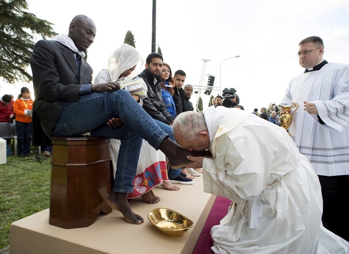 Image result for Images of Pope Francis performs a foot-washing ritual at the Castelnuovo di Porto refugee centre near Rome on 24 March 2016