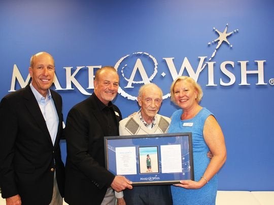 Hartley Gaylord, center, recently accepted a plaque recognizing his late wife Sandy's generous donation. 