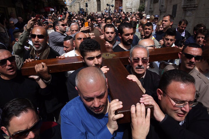 Arab Christian pilgrims carry a wooden cross along the Via Dolorosa (Way of Suffering) in Jerusalem's Old City during the Good Friday procession on March 25.