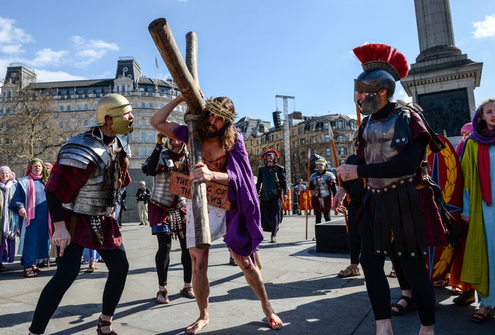 Actor James Burke-Dunsmore carries the crucifix whilst playing Jesus during The Wintershall's 'The Passion of Jesus' in front of crowds on Good Friday at Trafalgar Square on March 25 in London, England.