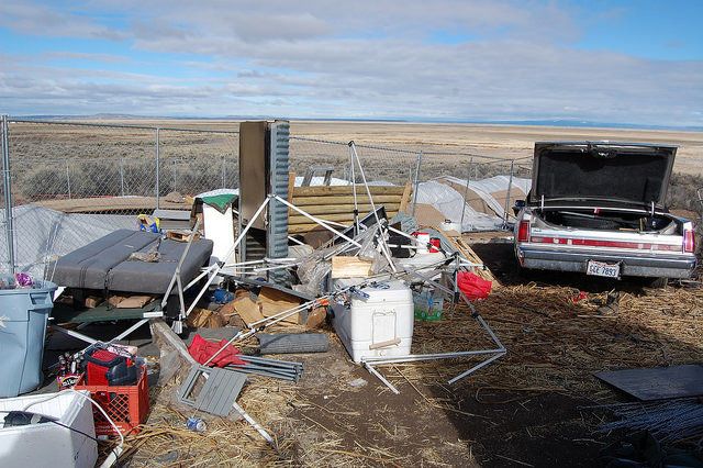 Trash, broken camping equipment and a neglected car litter the area around the Malheur National Wildlife Refuge.
