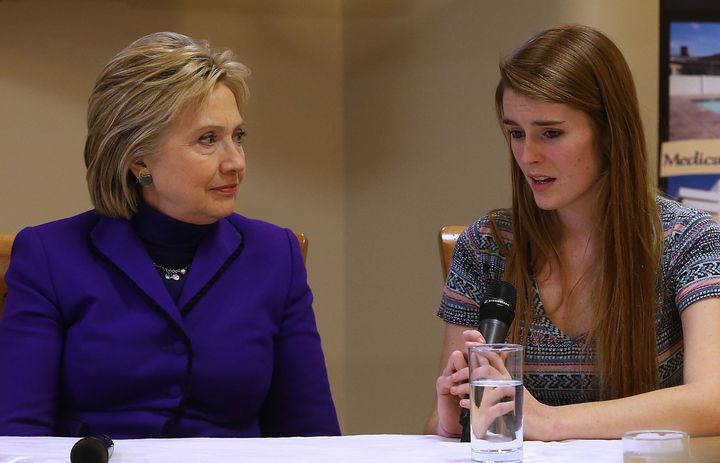 Democratic presidential candidate Hillary Clinton (L) looks on as Samantha, a patient at The Farnum Center alcohol and drug treatment facility, tells her story of recovering from heroin addiction on Feb. 5, 2016, in Manchester, New Hampshire.