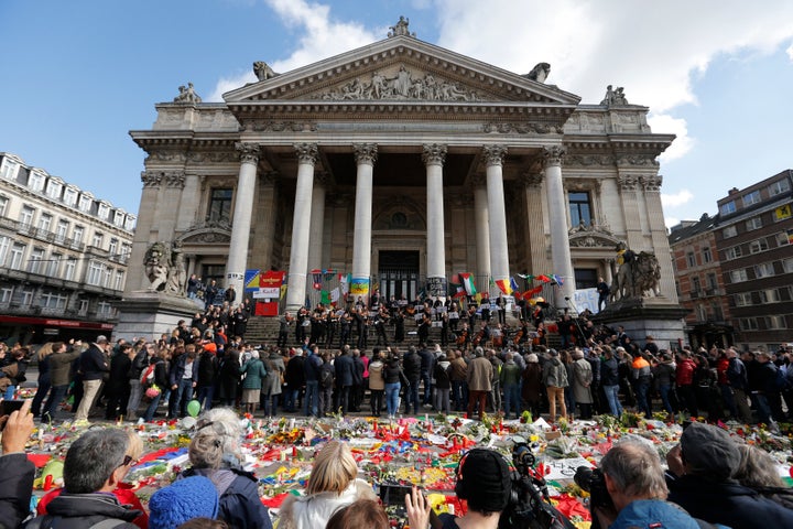The Brussels Philharmonic Orchestra plays on the steps of the old stock exchange building in Brussels following Tuesday's bom
