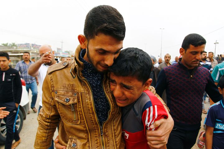 Iraqis mourn at a funeral after an Islamic State suicide bomber killed 26 people at a soccer match on Friday.