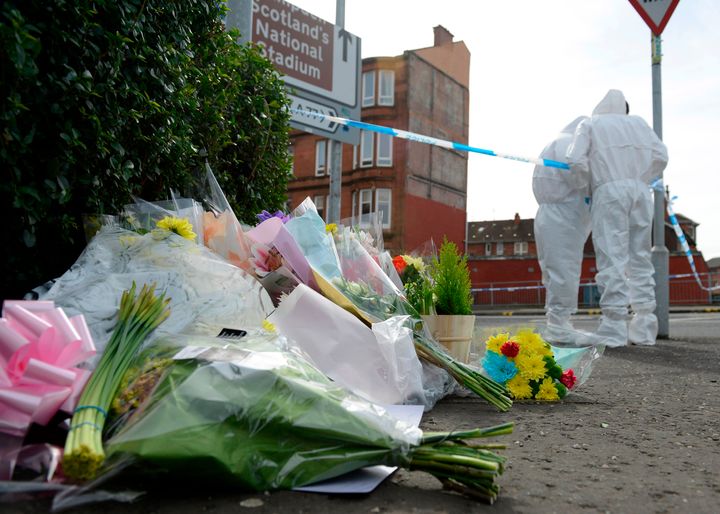 Flowers are left at the Shawlands, Glasgow, scene where Shah was killed