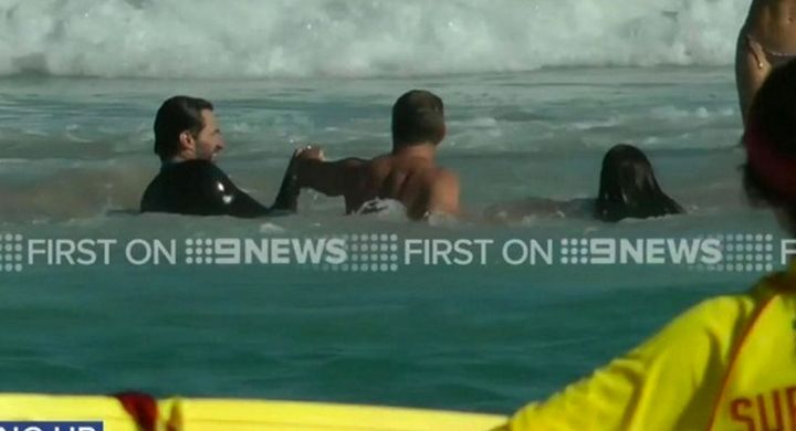 Hugh Jackman, left, helps swimmers from a dangerous rip at Sydney's Bondi Beach
