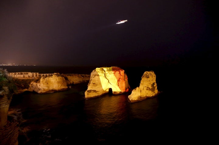 The Pigeon Rock in Beirut, Lebanon, is illuminated in the colours of the Belgian flag in a gesture of solidarity over the suicide attacks in Brussels.