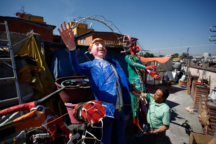 Craftsman Felipe Linares is seen here putting the final touches to the effigy depicting Donald Trump, before it was set on fire.