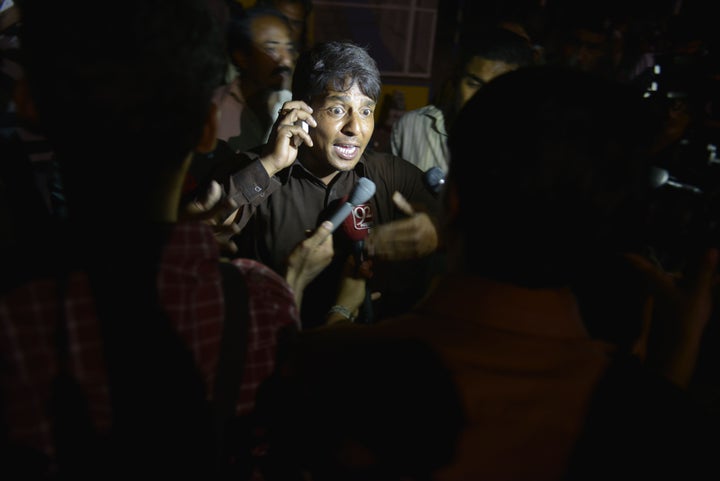A Pakistani eye witness talks with media representatives at a bomb blast site in Lahore on March 27, 2016. Dozens were killed