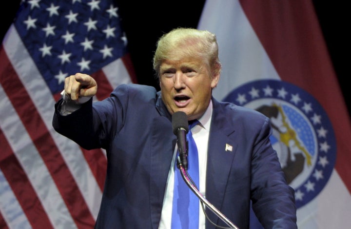 Donald Trump points out a protester during a campaign rally at the downtown Midland Theater in Kansas City, Missouri, March 12, 2016