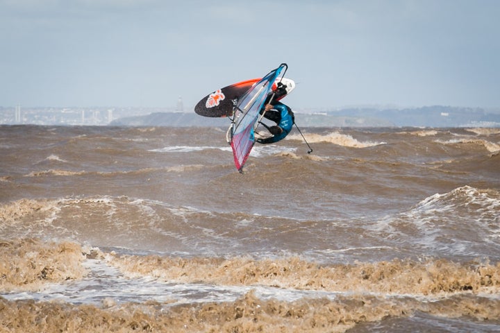 A windsurfer performs a front flip whilst taking advantage of high winds at Weston-super-Mare, Somerset