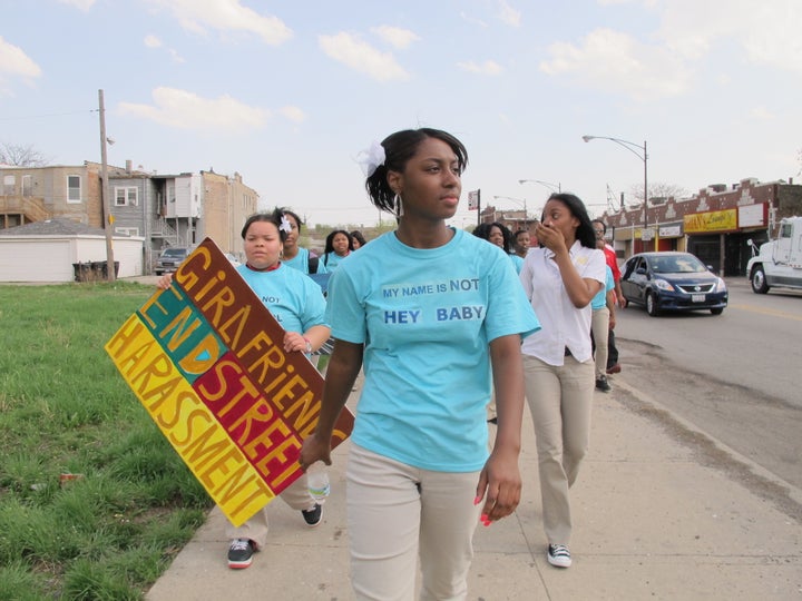 Participants with A Long Walk Home stage a neighborhood march on International Anti-Street Harassment Day.