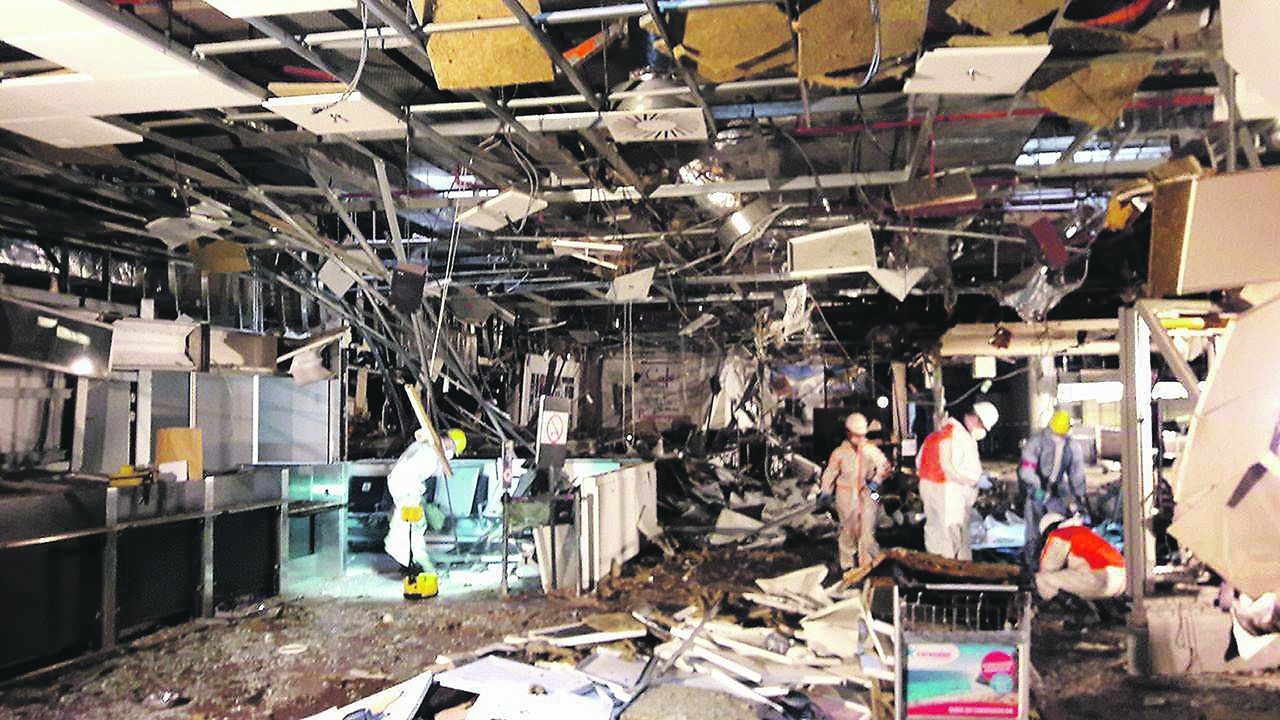 Newly released images show the damage to Brussels' international airport a day after the March 22 terrorist attacks.