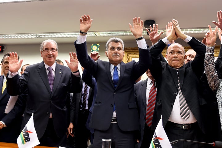 Brazil's PMDB party lawmakers Eduardo Cunha (left), president of the lower chamber, senators Romero Juca (center) and former Civil Aviation Minister Eliseu Padilha, vote for leaving the government coalition, at the PMDB's headquarters in Brasilia, on March 29, 2016.