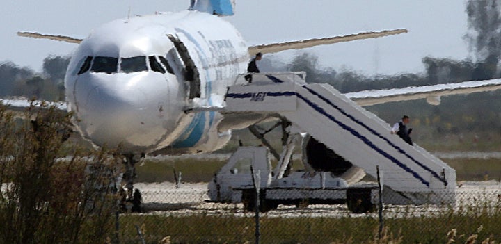 People are seen leaving the plane after the hijacking