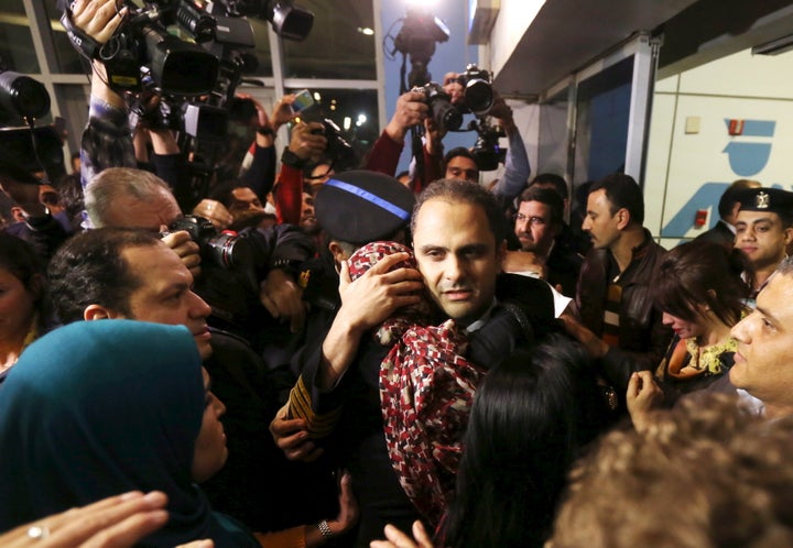 The flight's pilot Amr al-Jamal embraces a family member after arriving at Cairo international airport