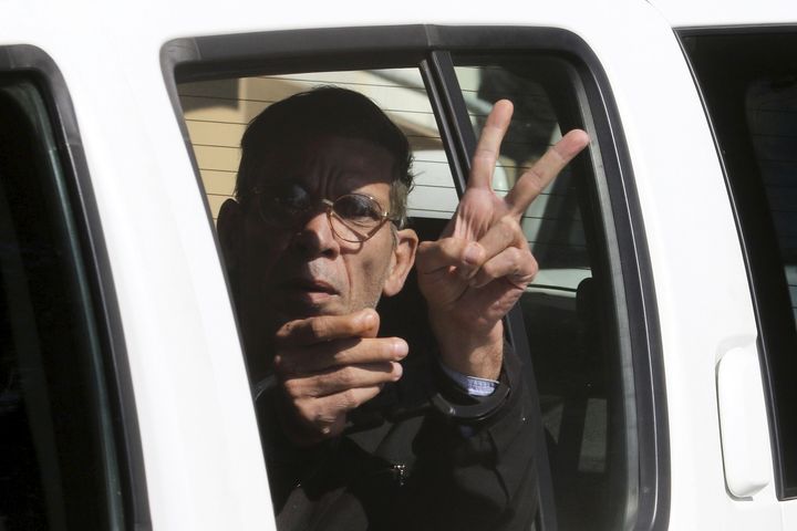 Seif El Din Mustafa gestures as he is transferred by Cypriot police from a court in Larnaca