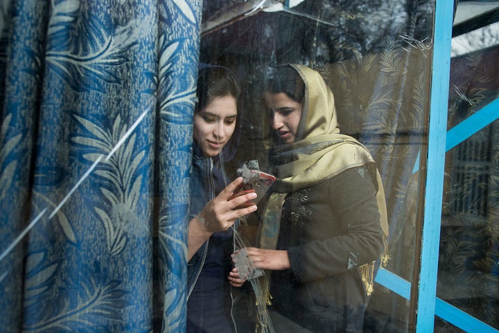 Parastoo Saqib and Shougofa Alikozay, two participants in the program, chat. Discussions at Sahar Speaks range from news like the opening of a new women-only swimming pool to taboo subjects like transgender people undergoing surgery.