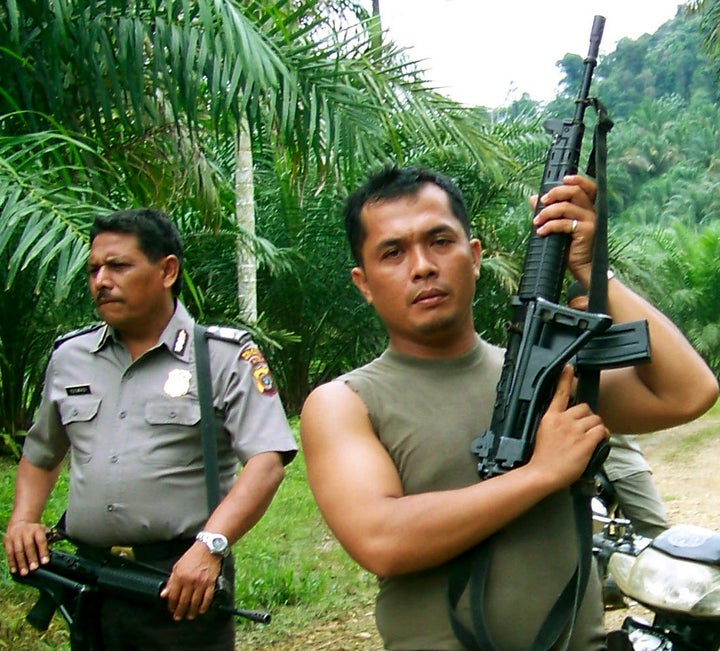 Police from the Aceh Tamiang district prepare to enter an illegal palm oil plantation inside the Leuser Ecosystem in 2009.