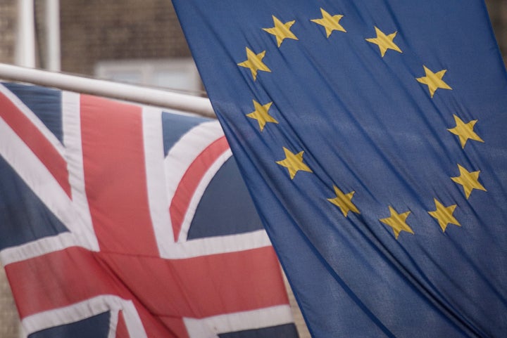 EU and UK flags fly above the EU Commission offices in Westminster, London