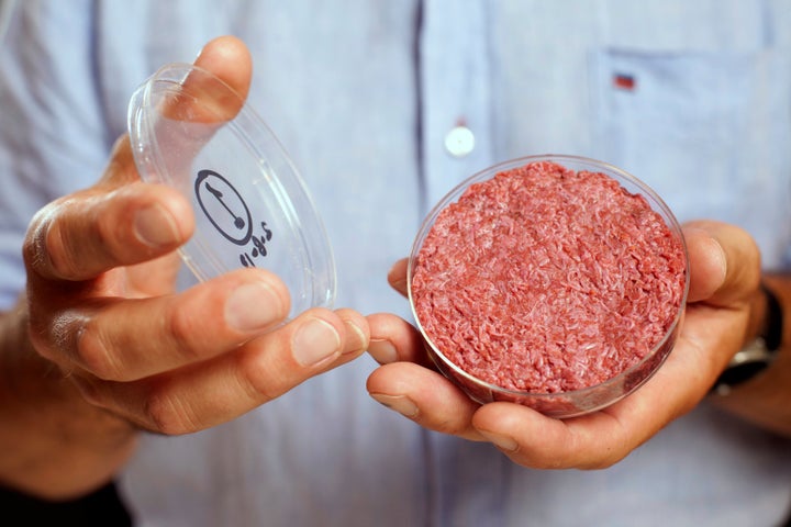 Professor Mark Post holds the world's first lab-grown beef burger during a launch event on Aug. 5, 2013. Post is just one of