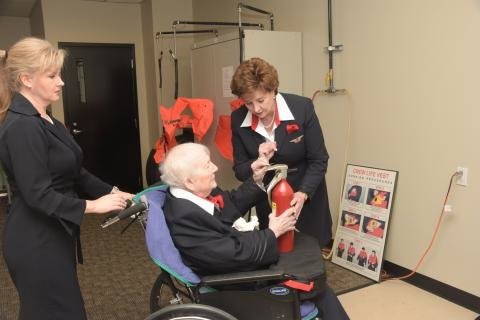 Clem Ferguson, 96, learns about safety procedures during Delta flight attendant training.