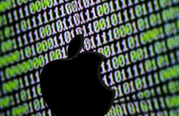 A 3D printed Apple logo is seen in front of a displayed cyber code in this illustration taken March 22, 2016. (REUTERS/Dado Ruvic/Illustration)