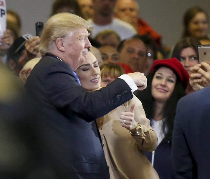 Real estate mogul Donald Trump poses with fans.