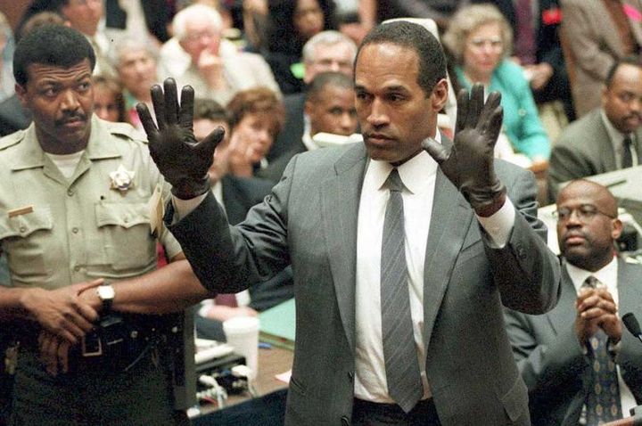O.J. Simpson shows the jury a new pair of Aris extra-large gloves, similar to the gloves found at the Bundy and Rockingham crime scene June 21, 1995, during his double murder trial in Los Angeles.