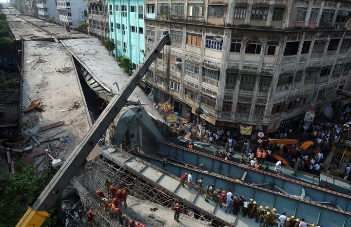 An overpass under construction collapsed in Kolkata, a major city in eastern India, killing at least 14 people with 100 people feared trapped.