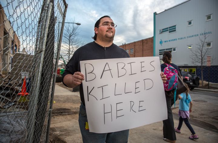 A man protesting outside of a Planned Parenthood.