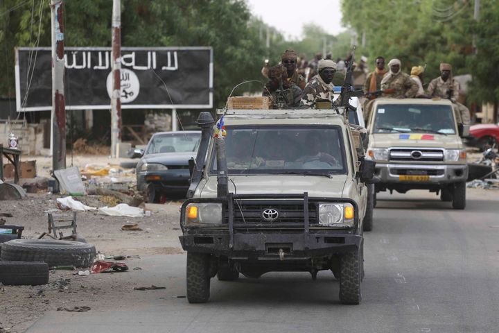 The kidnap of hundreds of women and children is the largest school abduction by Boko Haram on record, Human Rights Watch said. A convoy of Chadian soldiers passes a Boko Haram sign in Damasak last March.