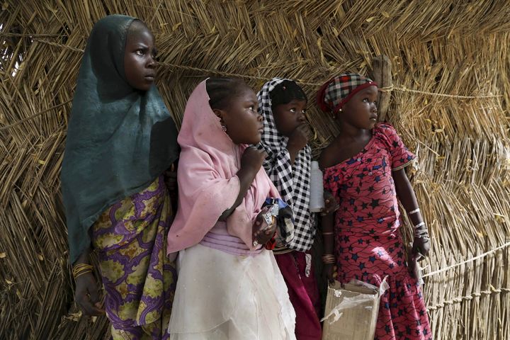 Parents of those kidnapped said they were too afraid of the government to speak out about the kidnapping. Above, girls watch soldiers from Niger and Chad after they recaptured Damasak from Boko Haram in March 2015.
