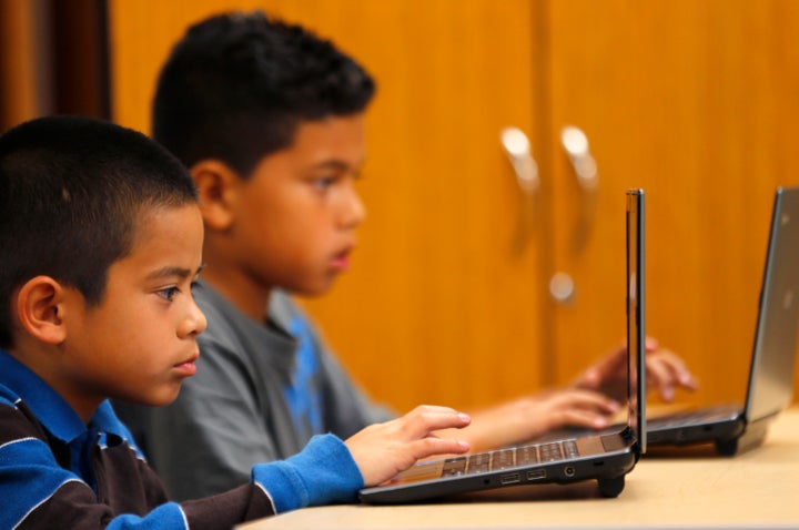 Students work on laptop computers at Monarch School in San Diego, California