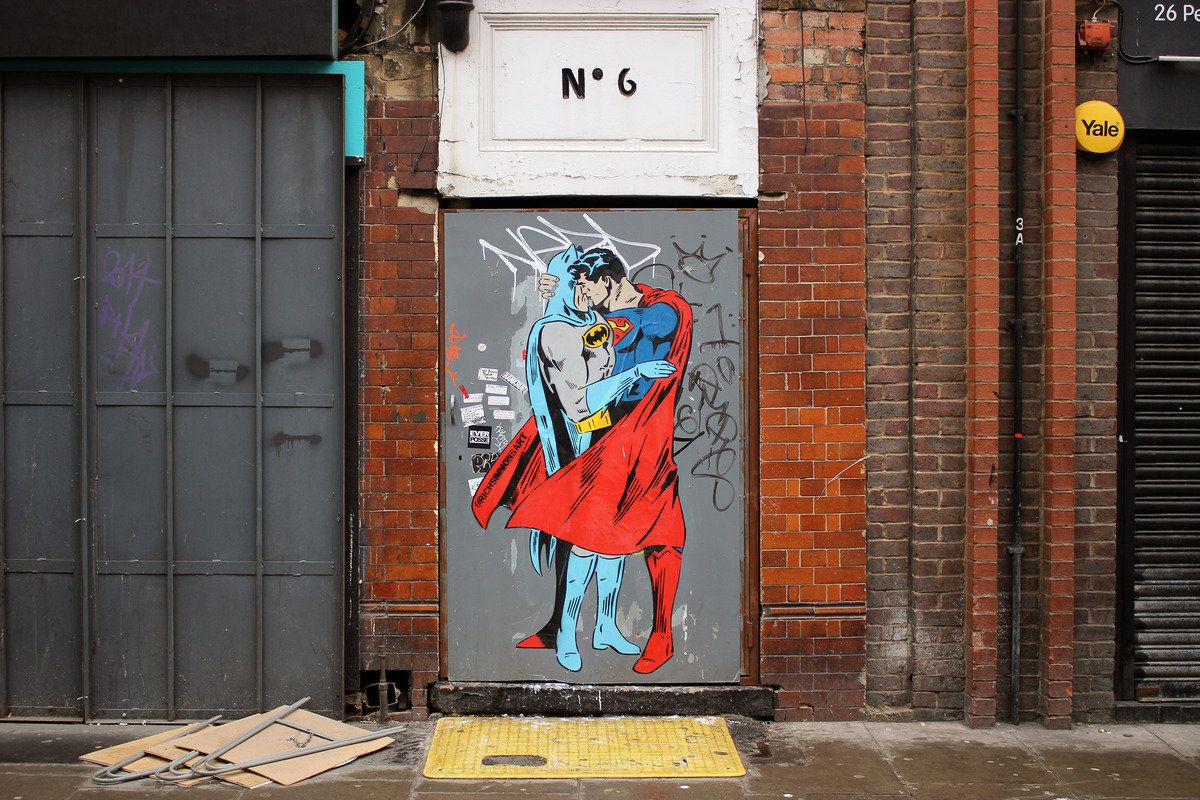 Two beloved superheroes share a kiss in this mural painted in Soho, London.