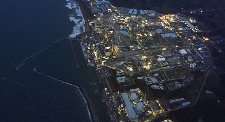 Tokyo Electric Power Co.'s tsunami-crippled Fukushima Daiichi nuclear power plant is illuminated for decommissioning operation in this aerial view photo taken March 10, 2016, a day before the five-year anniversary of the 2011 earthquake and tsunami disaster.