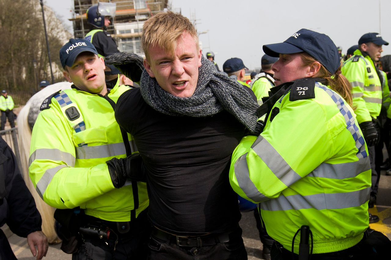 A man is led away by police as anti-racism demonstrators block the route of a planned far right march through Dover.
