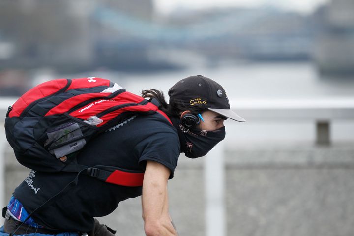A cycling on London Bridge in April 2014, when industrial pollution and Sahara dust blanketed the country in smog
