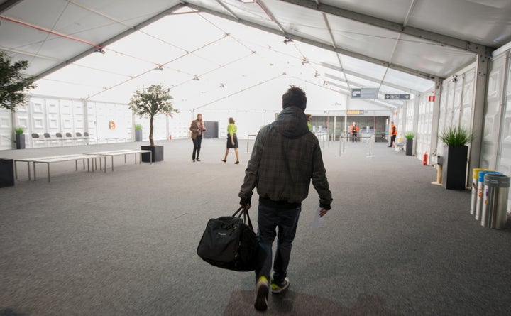 A passenger arrives at Brussels Airport, which partially re-opened following a bomb blast 12 days ago, in Zaventem, Belgium A