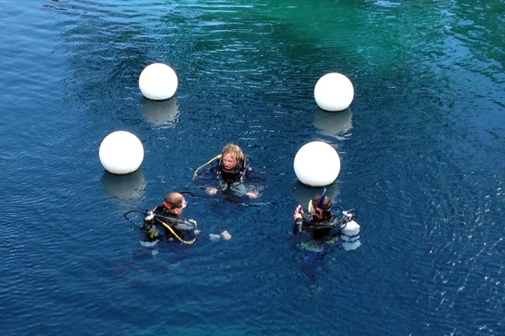 The swimming hole is a popular location for scuba training because of its clear waters. Here, some divers are seen last summer.